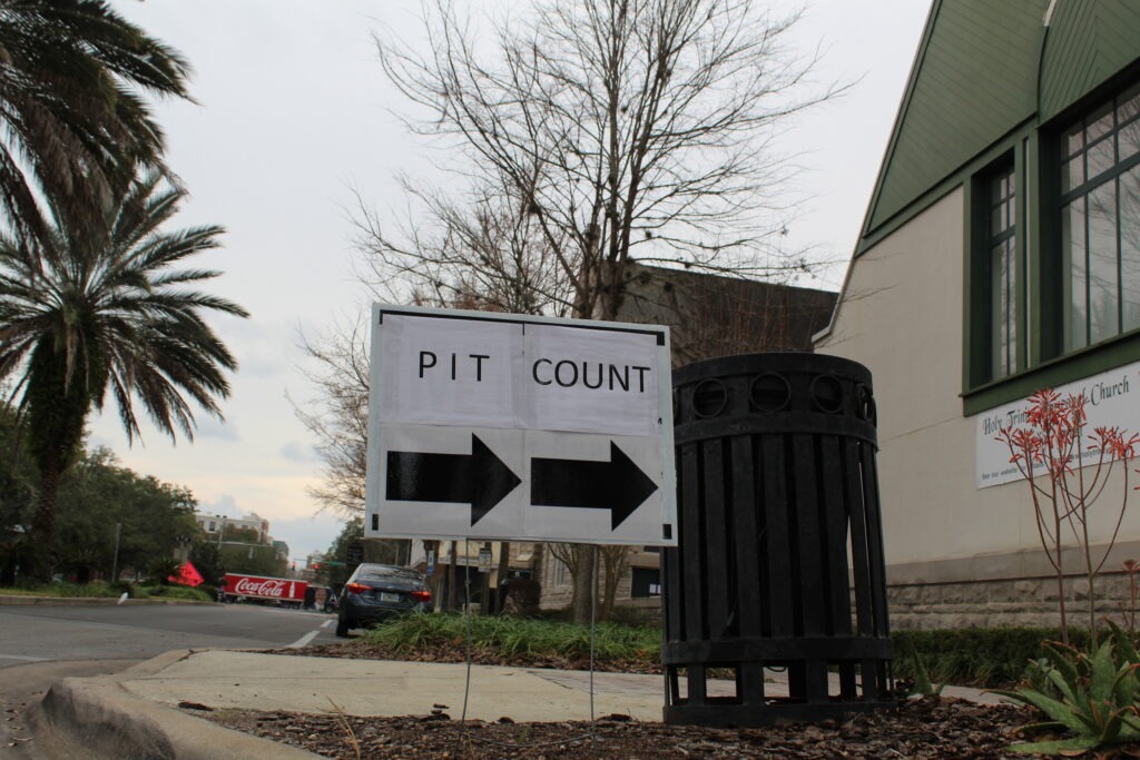 PIT Count directional sign with arrows in front of building